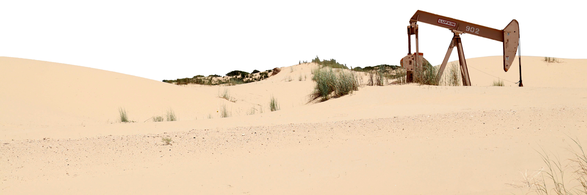 Pump jack in the desert dunes